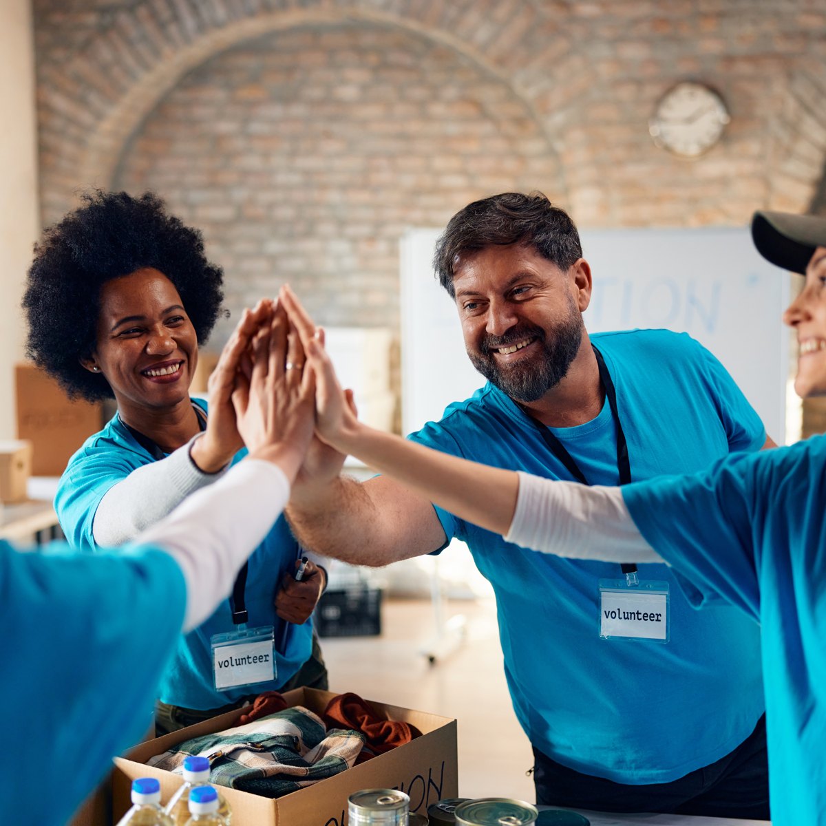 Nonprofit volunteers celebrating with a high five